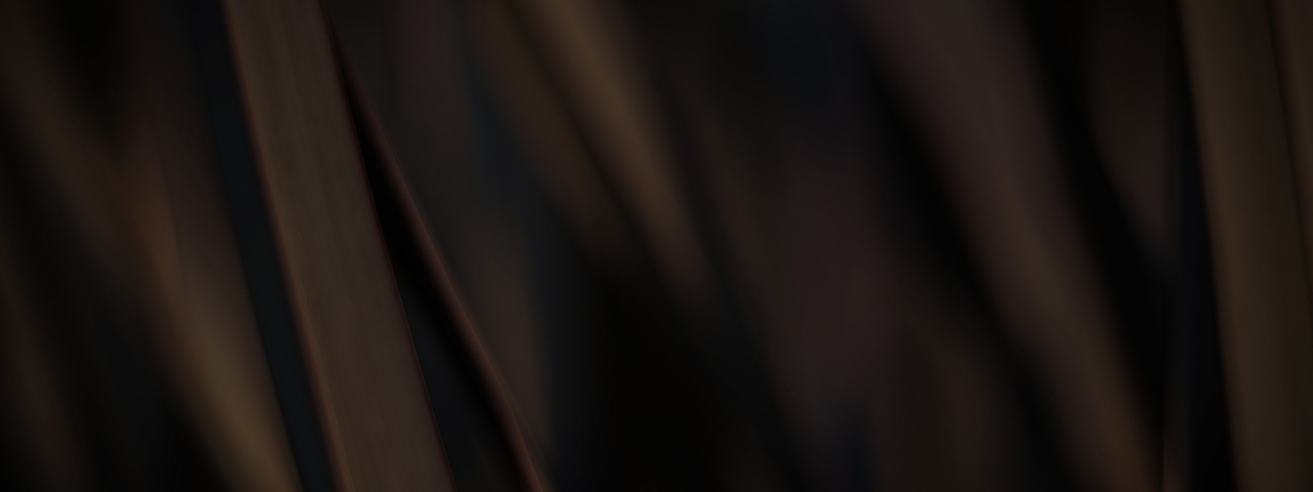 Abstract dark textured background with blurred lines.