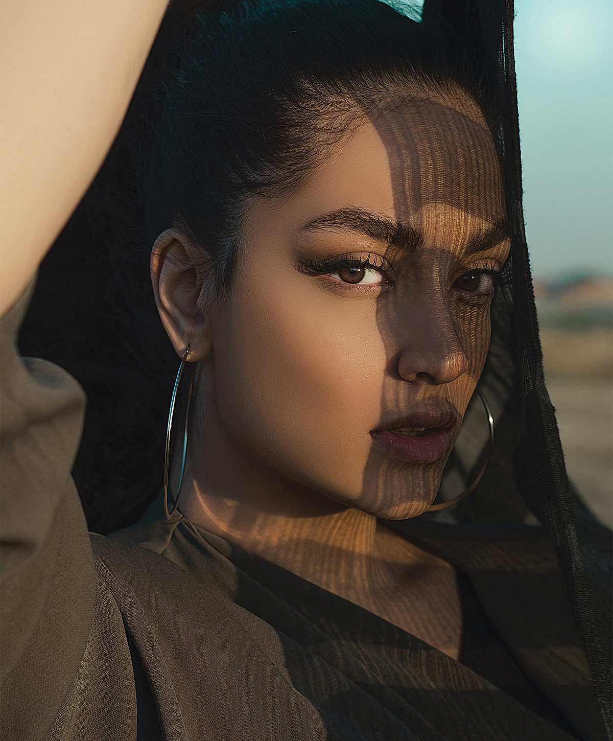 Portrait of a woman with shadows on her face.