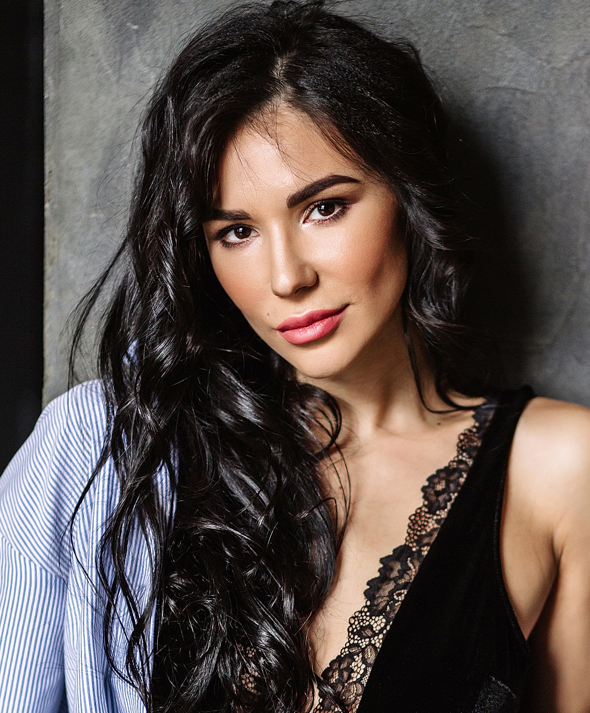 Woman with long hair and stylish outfit.