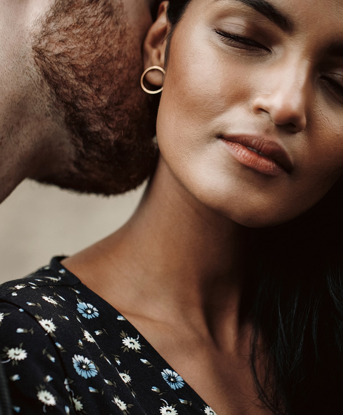 Couple sharing an intimate moment, eyes closed.